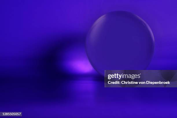 magic glass sphere on blue background - magic ball stockfoto's en -beelden