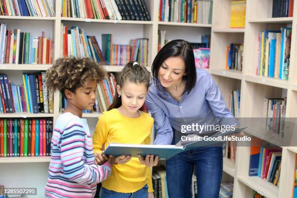children in a library - librarian reading stock pictures, royalty-free photos & images