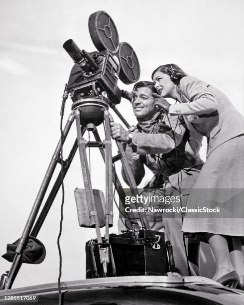 1930s 1938 Clark Gable And Myrna Loy Too Hot To Handle Movie Still Posed Looking Through Finder On Tripod Mounted Film Camera