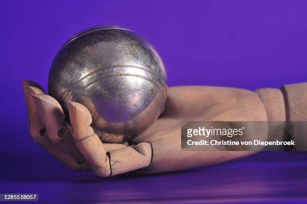 dolls hand with metall ball - boule noel stock-fotos und bilder
