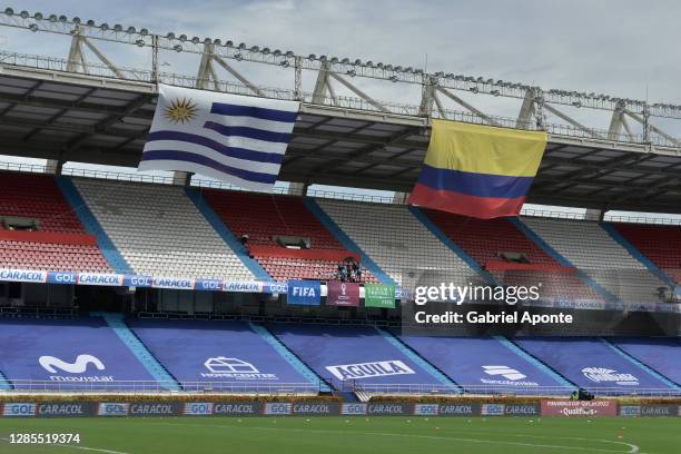 Flags of Uruguay and Colombia wave over the empty stands before a match between Colombia and Uruguay as part of South American Qualifiers for Qatar...