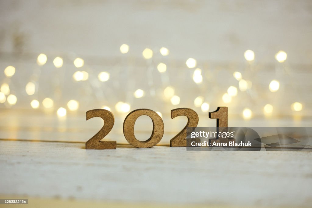 2021 New Year Number. Festive Card with blurred fairy lights and white shiny background.