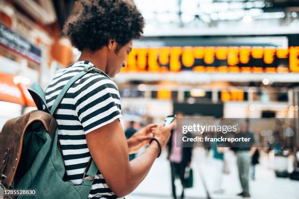 man using the phone in the station - railway station uk stock pictures, royalty-free photos & images