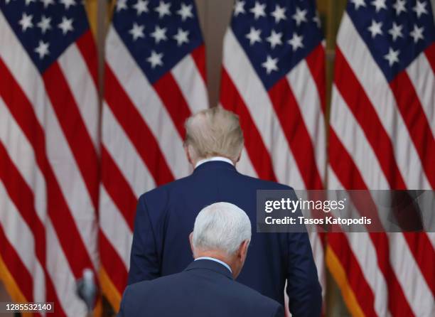 President Donald Trump and Vice President Mike Pence walk away after speaking about Operation Warp Speed in the Rose Garden at the White House on...