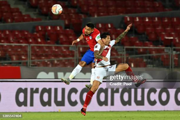 Paulo Díaz of Chile heads the ball against Gianluca Lapadula of Peru during a match between Chile and Peru as part of South American Qualifiers for...