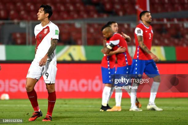 Gianluca Lapadula of Peru reacts as players of Chile celebrate their win a match between Chile and Peru as part of South American Qualifiers for...