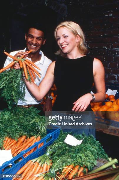 Michael Dierks und Diana Staehly, beide Schauspieler, am Gemüsestand, Deutschland 1999.