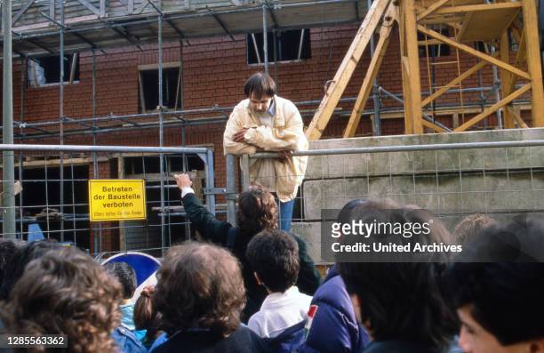 Armin Schröder, ein in Hamburg einschlägig bekannter "Klettermaxe", steigt von einem Kran in der Innenstadt von Hamburg, Deutschland 1989.