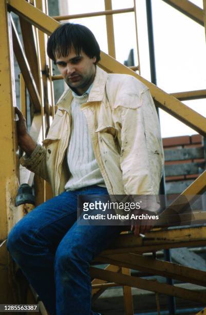 Armin Schröder, ein in Hamburg einschlägig bekannter "Klettermaxe", steigt von einem Kran in der Innenstadt von Hamburg, Deutschland 1989.