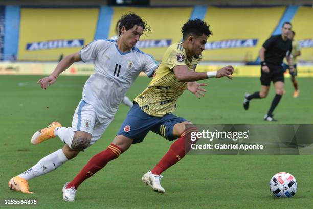 Luis Diaz of Colombia drives the ball while followed by Darwin Nuñez of Uruguay during a match between Colombia and Uruguay as part of South American...