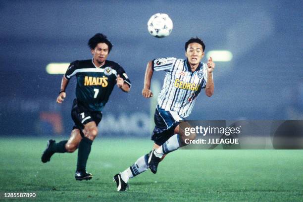 Yoshiyuki Shinoda of Avispa Fukuoka and Masakiyo Maezono of Verdy Kawasaki compete for the ball during the J.League second stage match between Verdy...