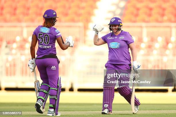 Rachel Priest of the Hurricanes and Hayley Matthews of the Hurricanes celebrate victory during the Women's Big Bash League WBBL match between the...