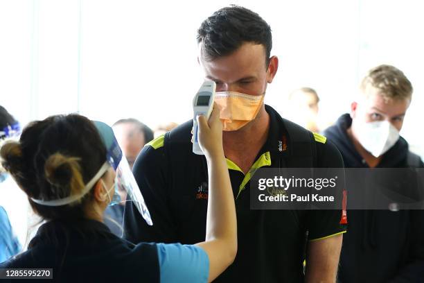 West Australian cricket player Ashton Turner has his temperature checked prior to G2G verification by West Australian police after arriving from...