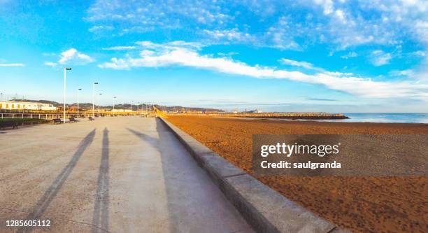 poniente beach in gijón at sunrise - promenade stock pictures, royalty-free photos & images