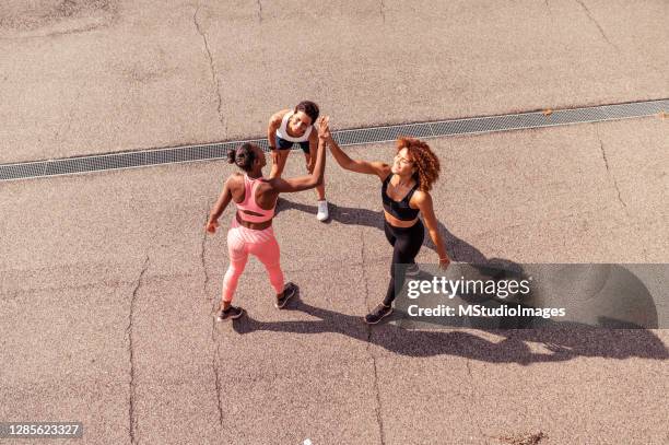 three women after a workout - runner warming up stock pictures, royalty-free photos & images