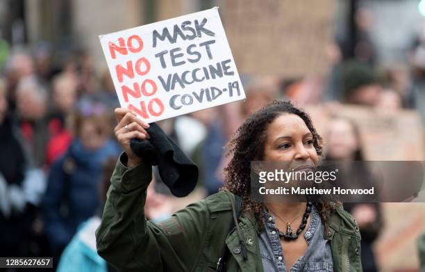 Protestors hold signs during the anti-lockdown protest on November 14, 2020 in Bristol, England. Police had warned protesters to cancel the march or...