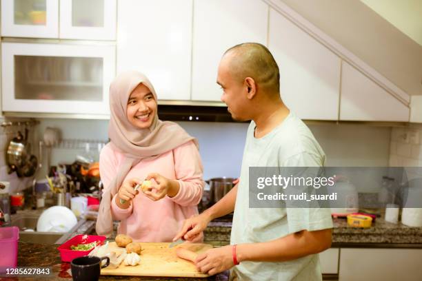 asian muslim couple cooking together - malay lover stock pictures, royalty-free photos & images