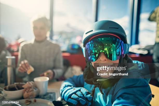 family having lunch in alpine ski restaurant - apres ski stock pictures, royalty-free photos & images