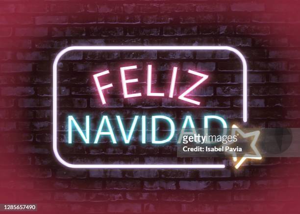 feliz navidad message in neon lights - feliz navidad stock pictures, royalty-free photos & images