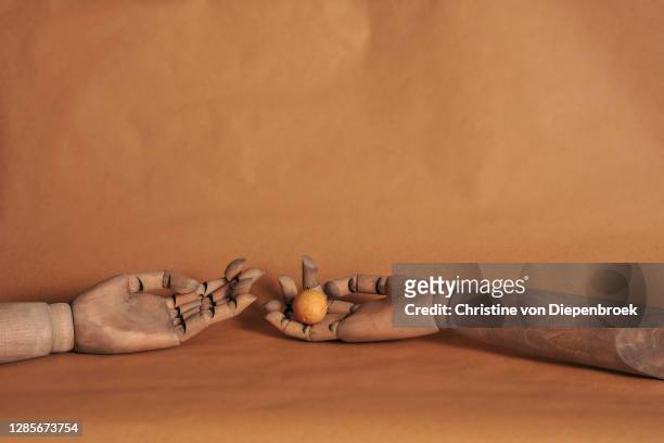 arm with sphere on brown background - mannequin arm stock pictures, royalty-free photos & images