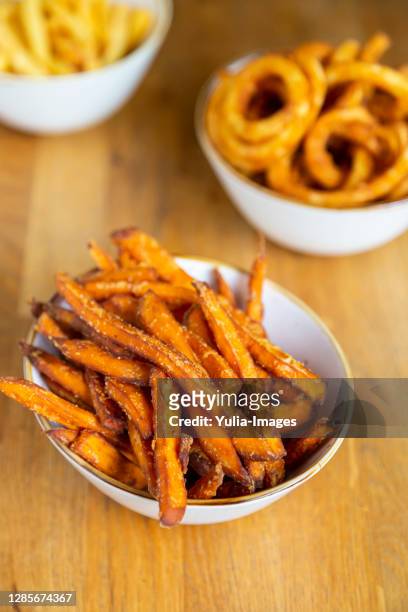 fried sweet potato chips in a bowl - sweet potato fries stock pictures, royalty-free photos & images