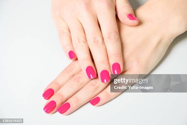 woman showing off manicure with bright pink polish - multi coloured nails stock pictures, royalty-free photos & images