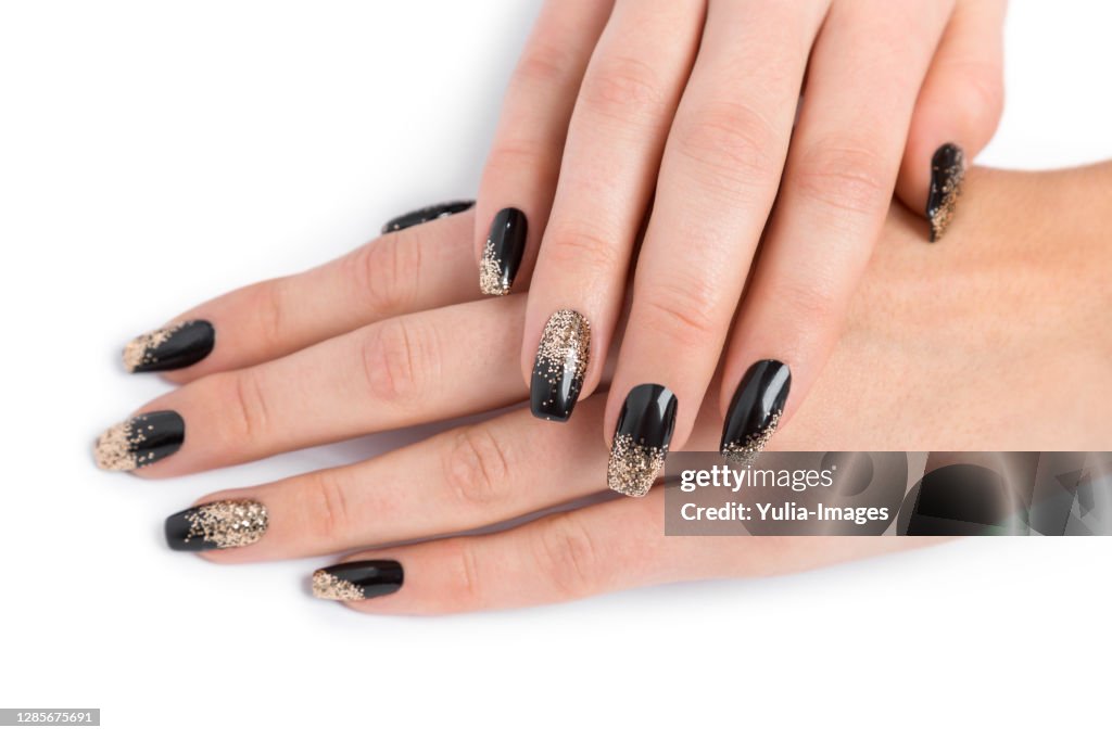 Close up of stylish manicured hands painted black