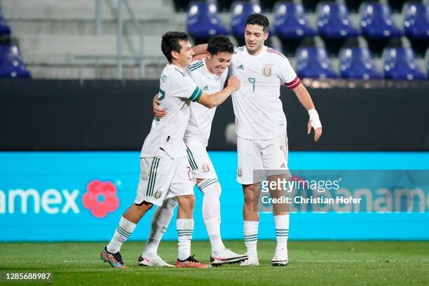 Carlos Salcedo celebrates with teammates Hirving Lozano and Raul Jimenez of Mexico after scoring his team's third goal during the international...
