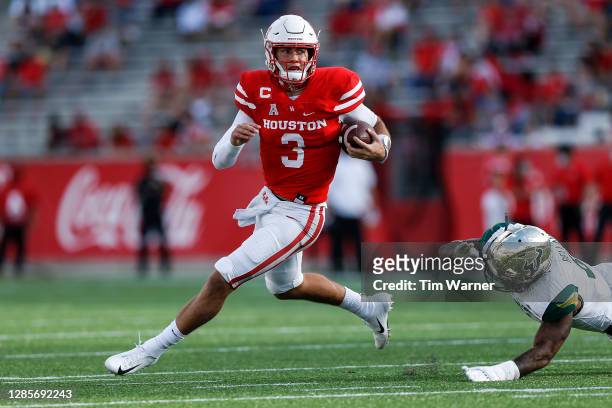 Clayton Tune of the Houston Cougars scrambles with the ball while pursued by Demaurez Bellamy of the South Florida Bulls in the first half on...