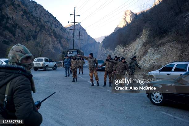 Soldiers divert traffic as Armenians flee the territories in Nagorno-Karabakh that will be handed over to Azerbaijan by midnight on November 14, 2020...