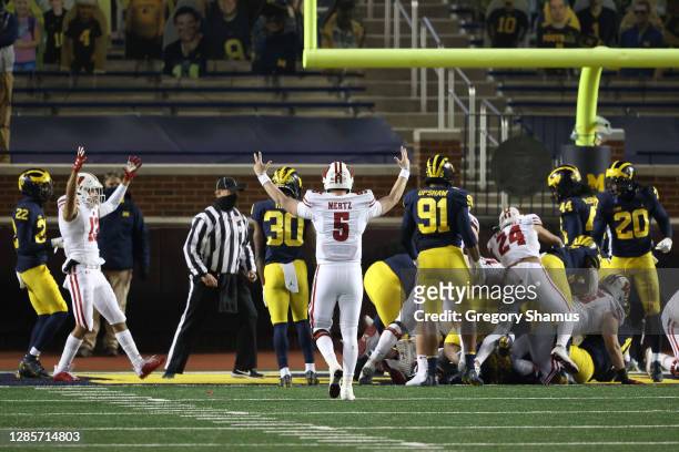 Graham Mertz of the Wisconsin Badgers celebrates a first half touchdown agains the Michigan Wolverines at Michigan Stadium on November 14, 2020 in...