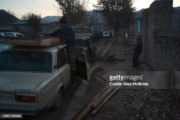 Boy carries his family's property out of their home as Armenians flee the territories in Nagorno-Karabakh that will be handed over to Azerbaijan by...
