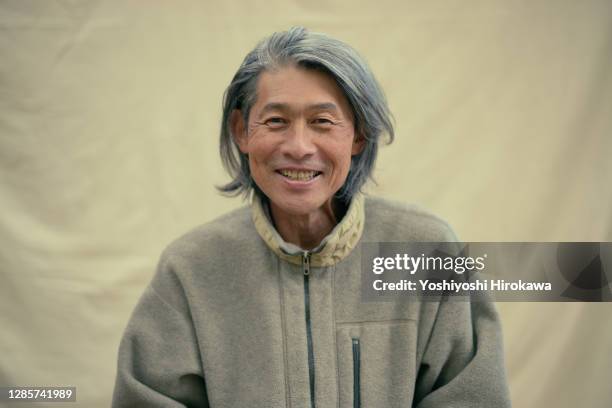 portrait of senior local surfer living marine on the coast - asiatischer mann freigestellt stock-fotos und bilder