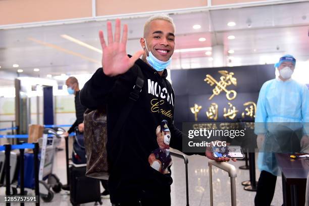 Alex Teixeira of Jiangsu Suning waves goodbye at an airport as he departs for home on November 15, 2020 in Nanjing, Jiangsu Province of China.