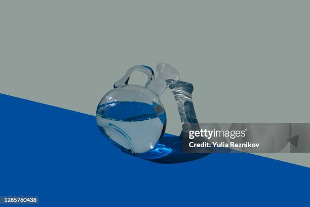 water in carafe on the blue-beige background - karaffin bildbanksfoton och bilder