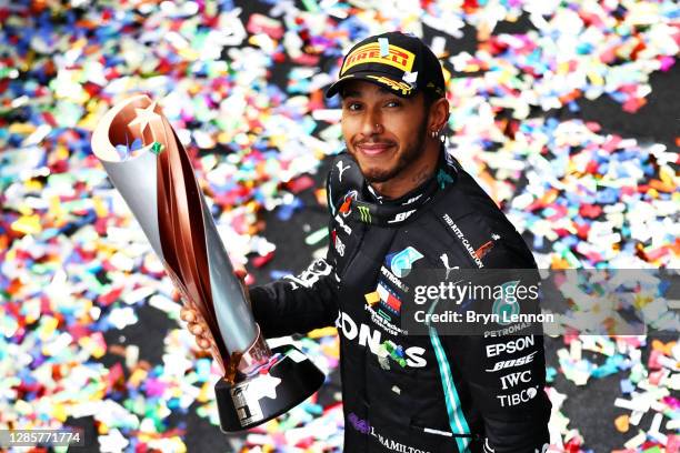 Race winner Lewis Hamilton of Great Britain and Mercedes GP celebrates winning a 7th F1 World Drivers Championship on the podium during the F1 Grand...