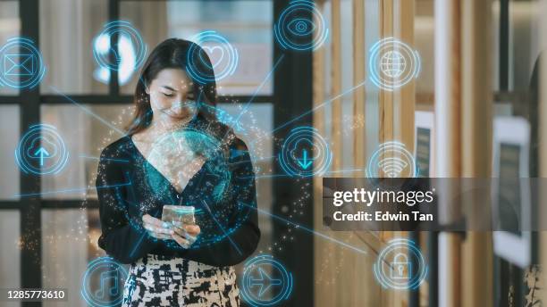 asian chinese turn on smart phone access to internet home automation - digital human face stock pictures, royalty-free photos & images