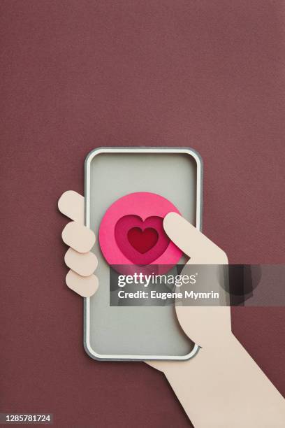 smartphone with heart shape on screen - paper art stock pictures, royalty-free photos & images