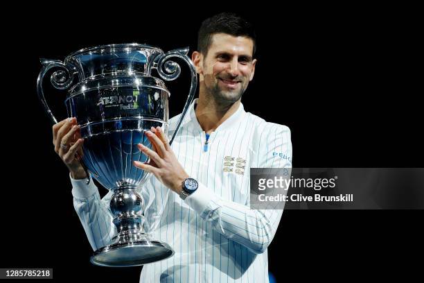 Novak Djokovic of Serbia poses with his trophy after being announced as ATP Tour end of year world number one during Day one of the Nitto ATP World...