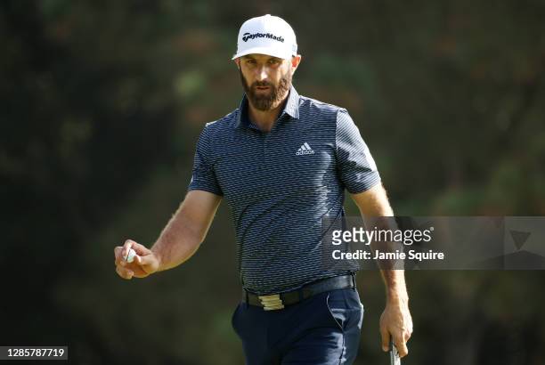 Dustin Johnson of the United States reacts after making a putt for par on the first green during the final round of the Masters at Augusta National...