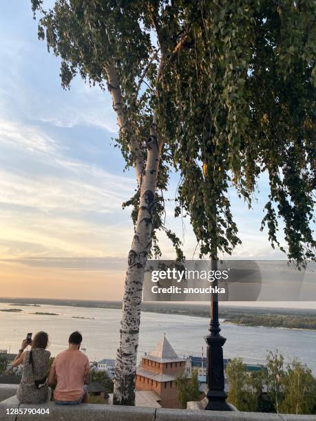 couple enjoying sunset on volga river - nizhny novgorod stock pictures, royalty-free photos & images