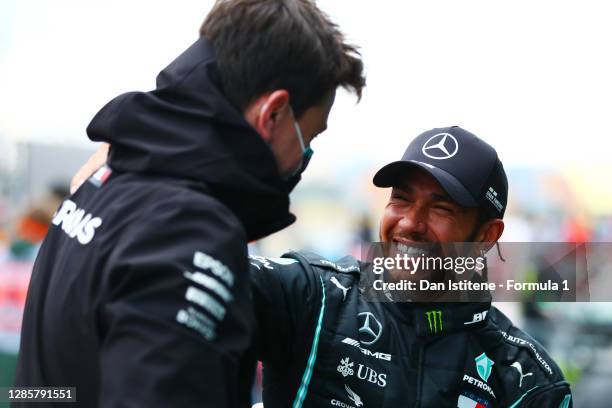 Race winner Lewis Hamilton of Great Britain and Mercedes GP celebrates winning a 7th F1 World Drivers Championship with Mercedes GP Executive...