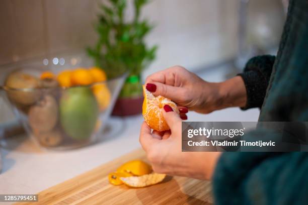 mandarin - peeling food stock pictures, royalty-free photos & images