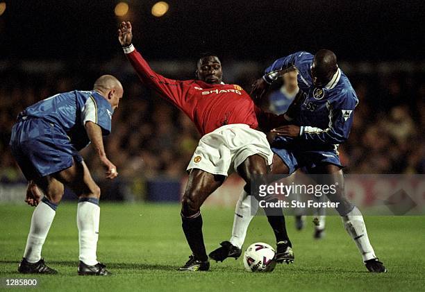 Andy Cole of Manchester United is closely watched by Frank Leboeuf and Bernard Lambourde of Chelsea in the FA Cup quarter-final replay at Stamford...