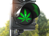 Cannabis leaf on green traffic light. Cannabis and marijuana legalization concept.