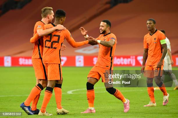 Memphis Depay of Netherlands celebrates with teammates Luuk de Jong, Denzel Dumfries and Georginio Wijnaldum of Netherlands after scoring his team's...