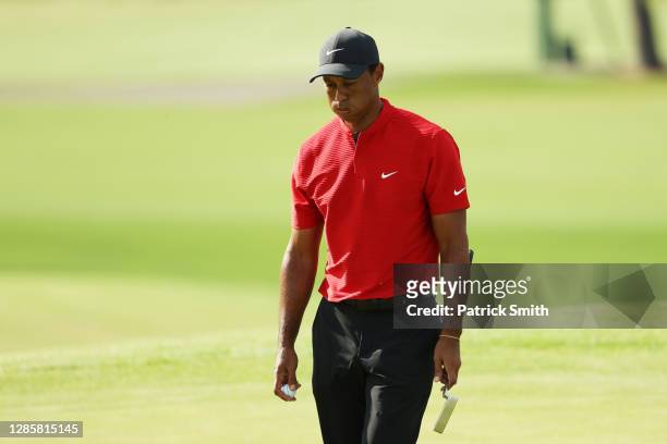 Tiger Woods of the United States reacts after putting on the 18th green during the final round of the Masters at Augusta National Golf Club on...