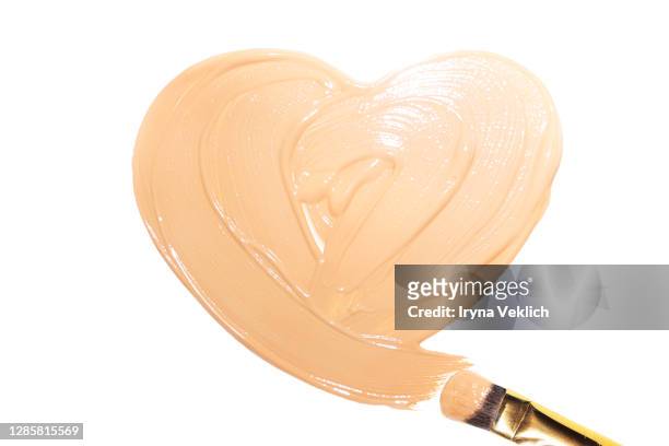 light beige smears of creamy foundation in shape of heart. - glace texture imagens e fotografias de stock