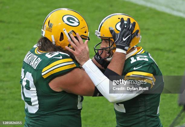 Aaron Rodgers of the Green Bay Packers celebrates a touchdown run with David Bakhtiari in the 2nd quarter against the Jacksonville Jaguars at Lambeau...