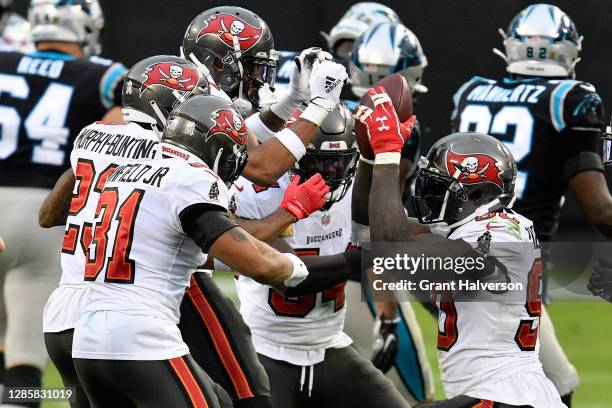 Jason Pierre-Paul of the Tampa Bay Buccaneers celebrates with his teammates after an interception of Teddy Bridgewater of the Carolina Panthers...